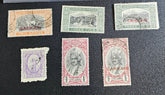 A collection of vintage Indian stamps from various feudatory states including Jhind, Bhopal, Saurashtra, Hyderabad, and Holkar, displayed on a flat surface.