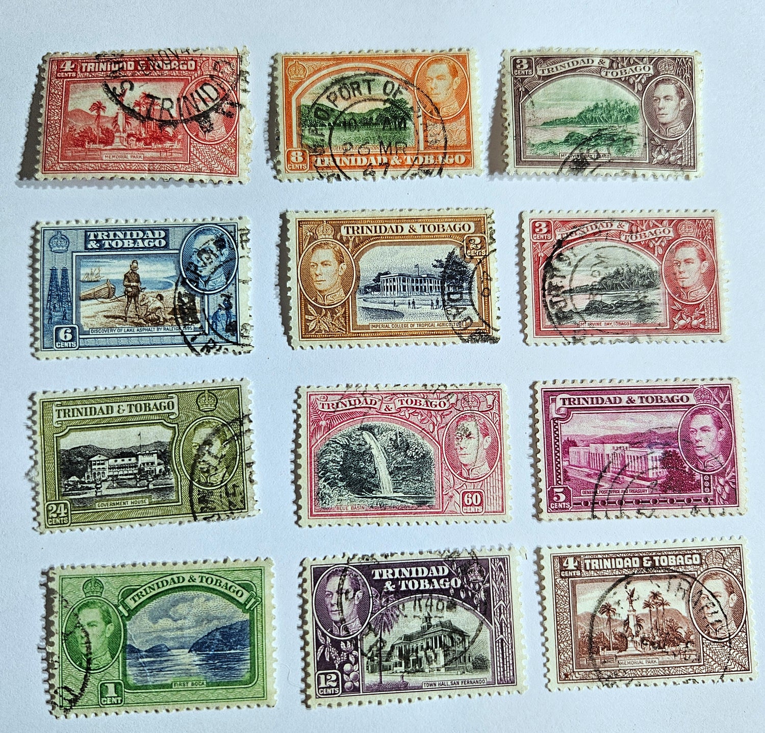 A collection of vintage Trinidad and Tobago stamps showcasing various colors and designs, featuring historical figures and landscapes.