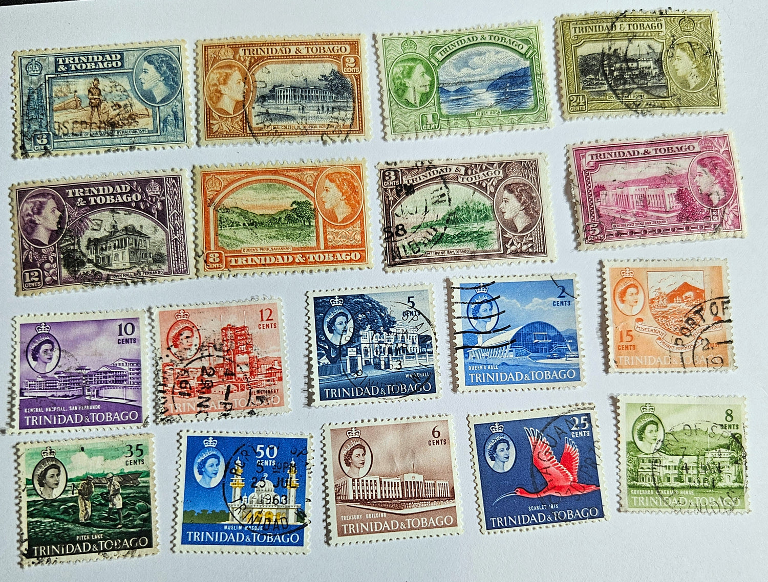 A collection of vintage Trinidad and Tobago stamps from the British Commonwealth era, displaying various colors and designs.
