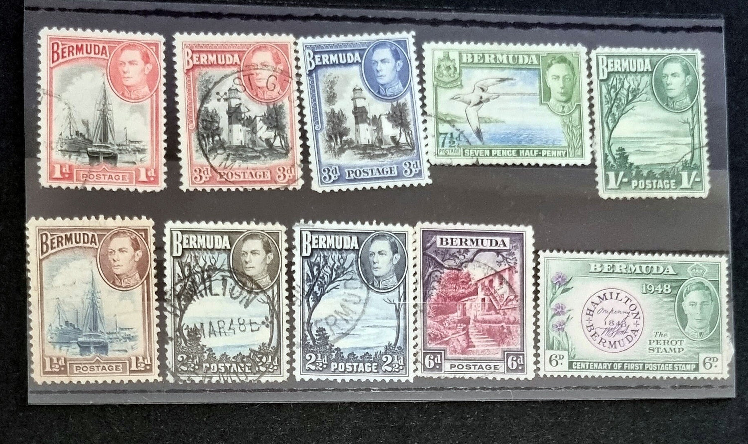 A collection of vintage Bermuda postage stamps displaying various designs and colors, arranged in a row.