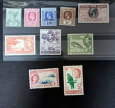 A collection of vintage Cayman Islands postage stamps featuring portraits of the British monarchy, with stamps from Queen Victoria to Queen Elizabeth II.