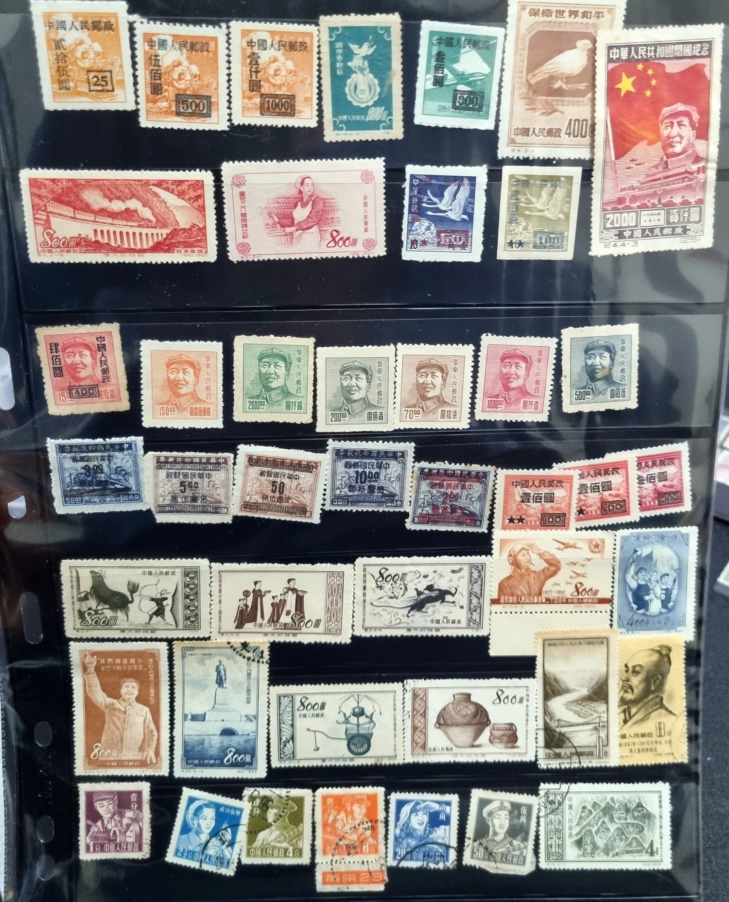 A collection of various Chinese stamps arranged in rows, showcasing different designs and colors.