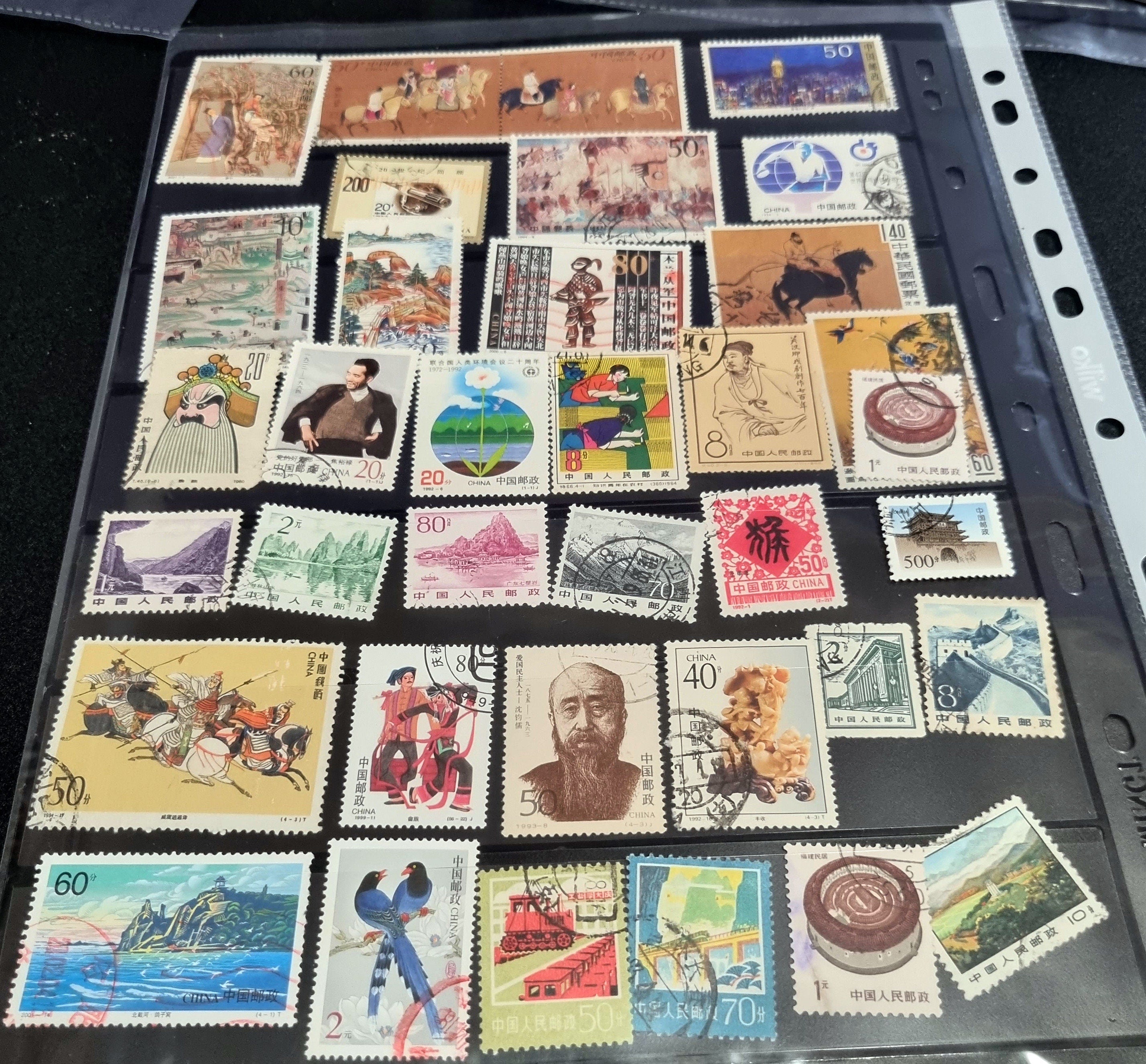 A collection of various Chinese stamps arranged in rows, showcasing different designs and colors.