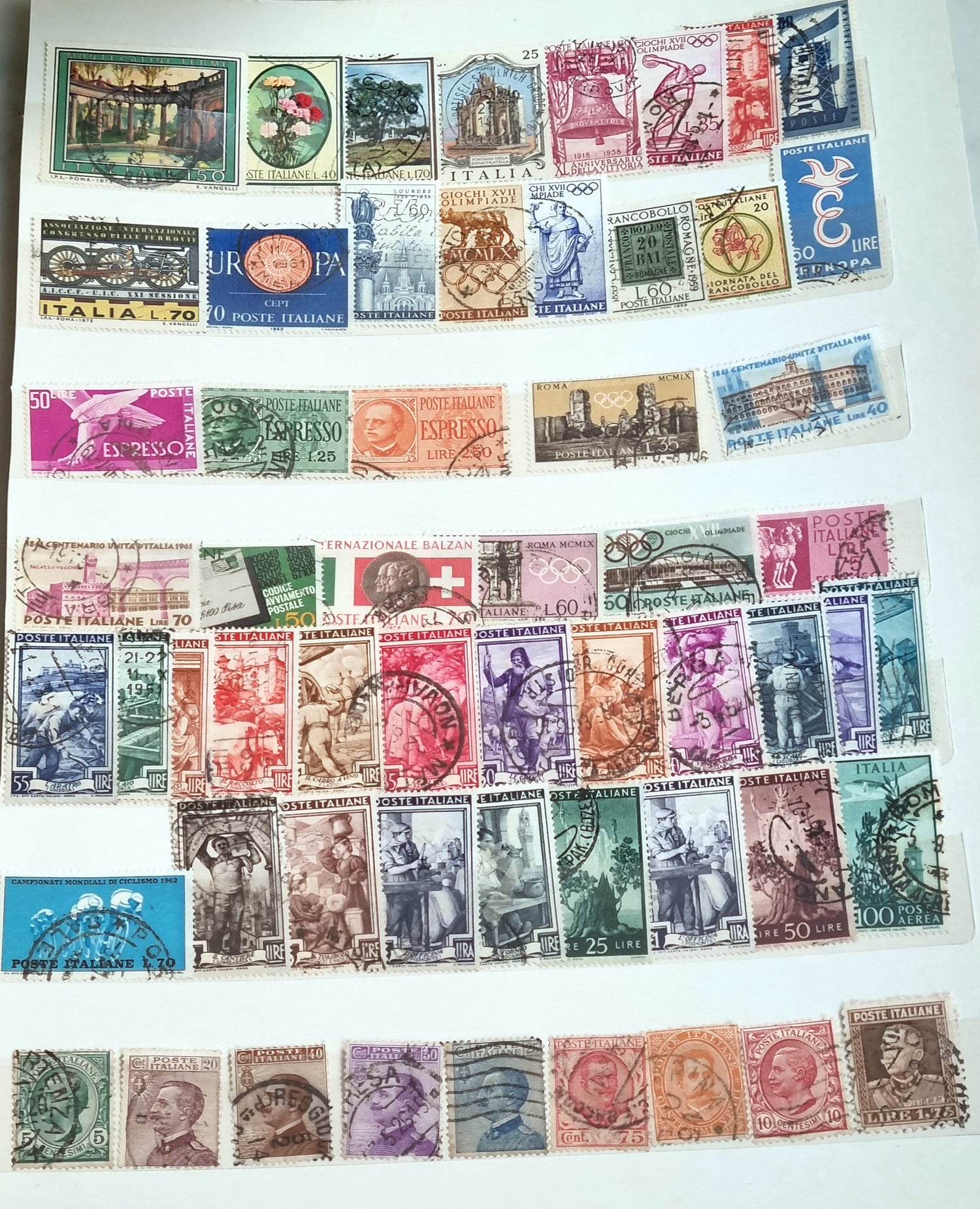 A collection of various vintage Italian postage stamps displayed in rows, with different colors and designs representing different regions or themes within Italy.