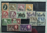 A display of various postage stamps from Kenya, Uganda, and Tanganyika featuring portraits of King George V, King George VI, and Queen Elizabeth II.