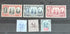 A collection of vintage Sarawak postage stamps displayed on a surface, showcasing various designs and colors including blue, red, and gray tones.
