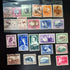 A collection of various vintage South West Africa stamps laid out on a surface.