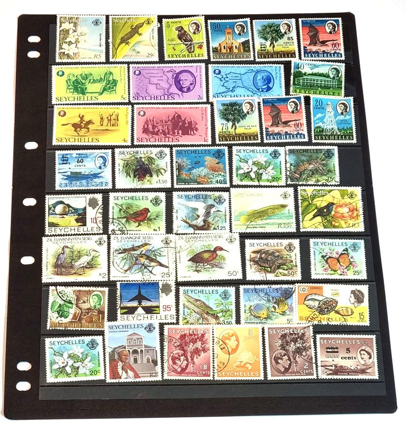 A collection of vintage Seychelles postage stamps displayed in a row, featuring various colors and denominations.