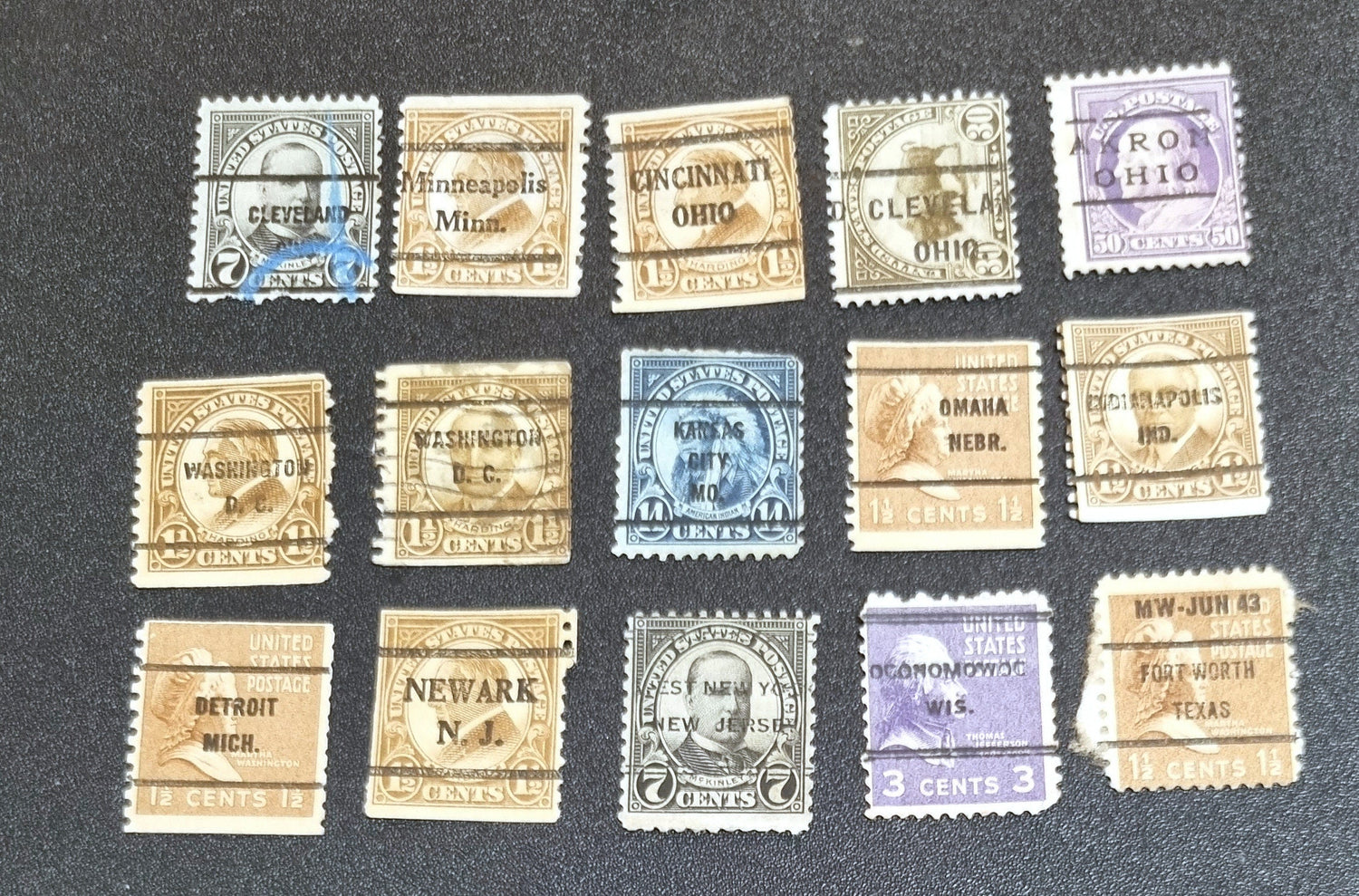 A collection of vintage USA postage stamps with various overprints and cancellations.