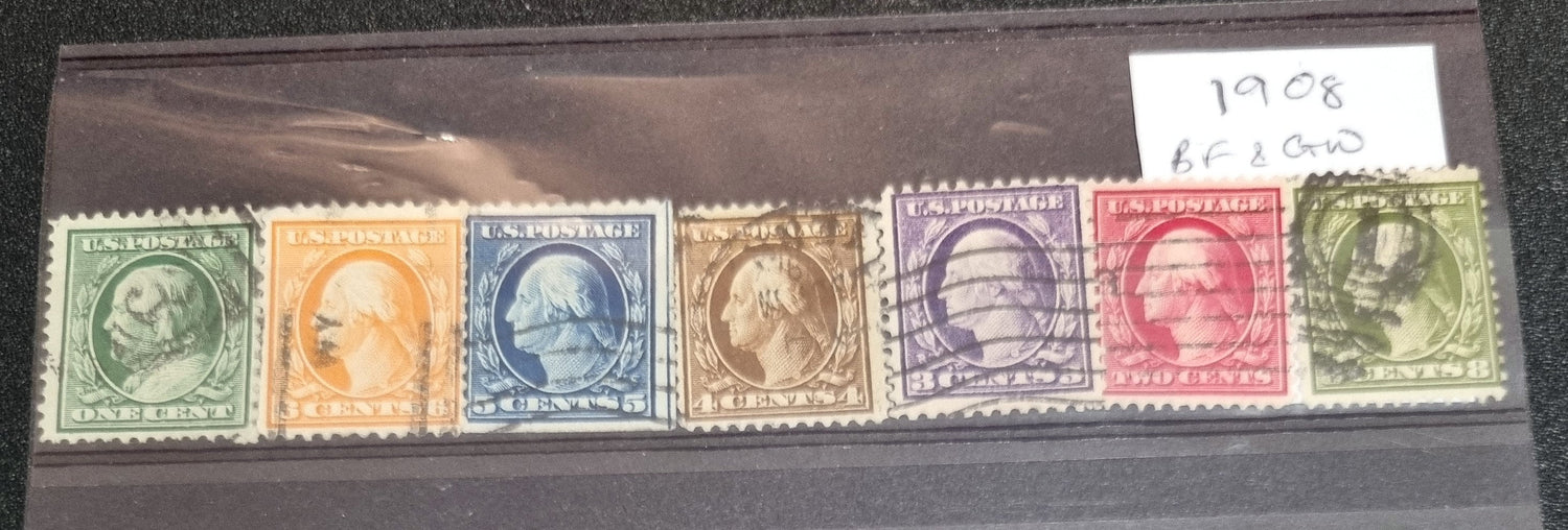 A collection of vintage US postage stamps featuring images of George Washington and Abraham Lincoln, among others, displayed in a case.