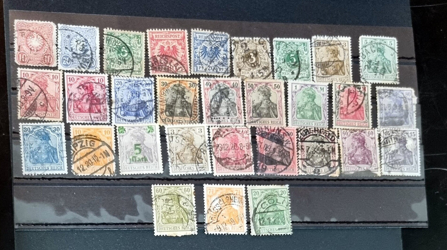 A selection of vintage German stamps from various regions and periods, displayed in a row.