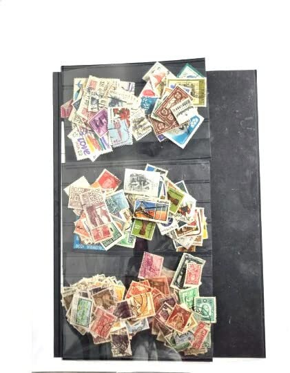 A collection of various postage stamps arranged in a pile, featuring different colors and designs, with no duplicates.