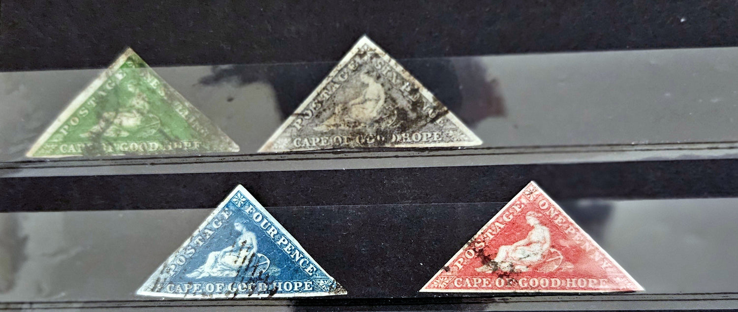 Four triangular stamps from Cape of Good Hope on a black background