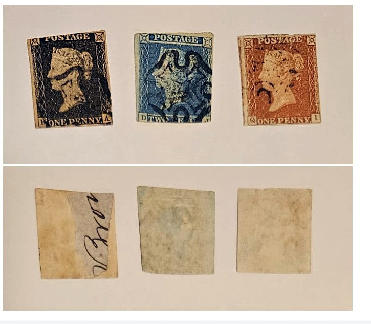 Three vintage British one penny postage stamps are shown above three blank or handwritten beige paper pieces on a light neutral background. The top row stamps are dark blue-black, blue, and reddish-brown, with &