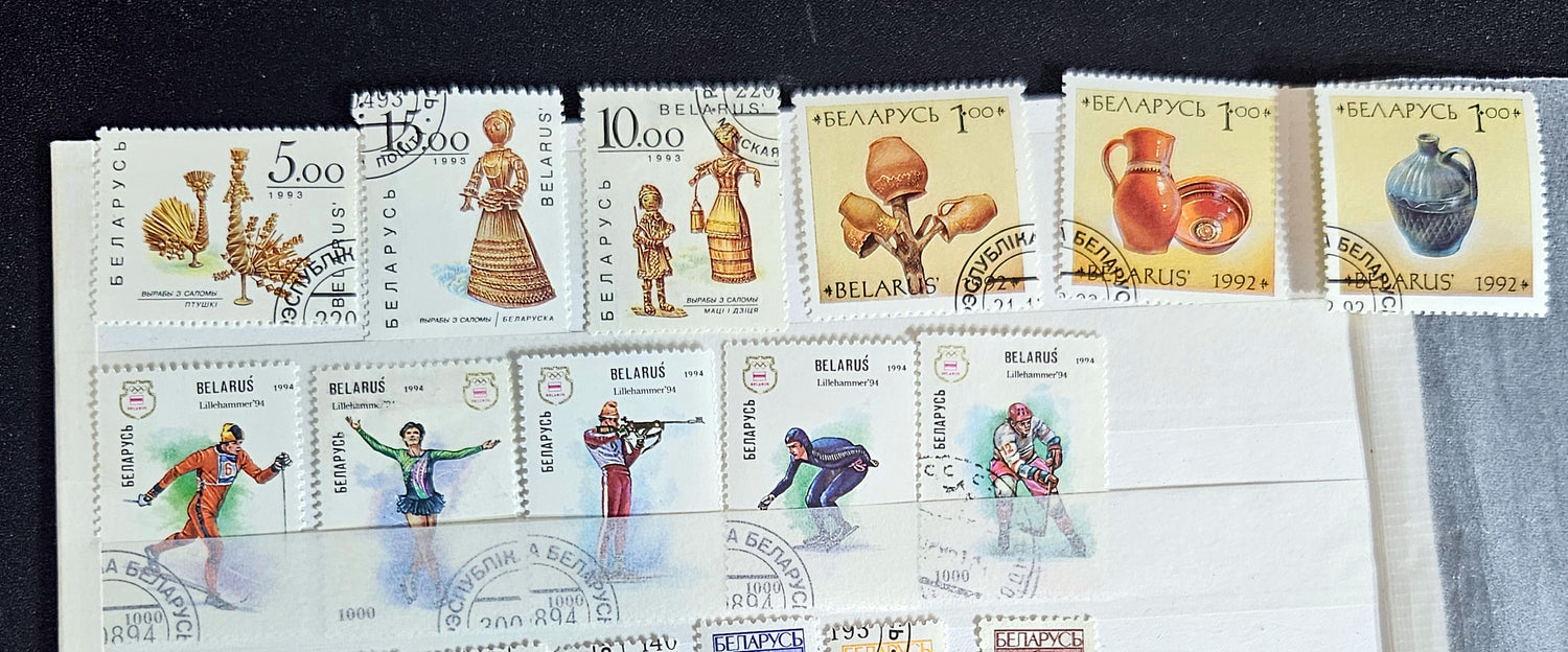 A collection of modern Belarusian stamps displayed in a row, featuring various designs including cultural figures and national symbols.