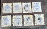 A collection of vintage postage stamps from the Orange Free State, featuring various denominations and cancellation marks, housed in a plastic sleeve.