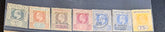 A row of vintage Seychelles postage stamps displayed side by side on a dark background, showing denominations from 3 cents to 75 cents with colors including green, orange, brown, red, blue, and yellow.