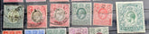 A close-up of several vintage postage stamps from British Somaliland, including red, green, blue, and purple denominations with black cancellation marks, arranged on a dark background.