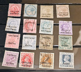 A set of 15 vintage British Indian postage stamps from Gwalior, arranged in a 3x5 grid on a dark display card. The stamps feature various colors including red, blue, purple, green, and brown, with some showing Queen Victoria&
