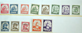 A set of vintage postage stamps arranged in two rows on a white background. The top row contains ten stamps in red, blue, green, brown, and purple colors, and the bottom row contains eight stamps in blue, brown, red, orange, and purple.