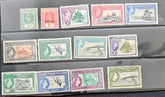 A set of vintage Gilbert and Ellice Islands postage stamps arranged in three rows on a dark display surface. The stamps feature various colors including green, red, pink, blue, and purple, with illustrations of landscapes, birds, and figures.