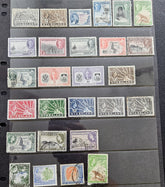A collection of vintage Nyaaland postage stamps displayed on a black plastic mounting sheet, showing various denominations and colors including green, blue, red, purple, and brown.