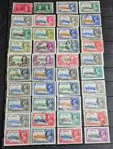 A collection of vintage postage stamps featuring various colors and designs, laid out in rows.