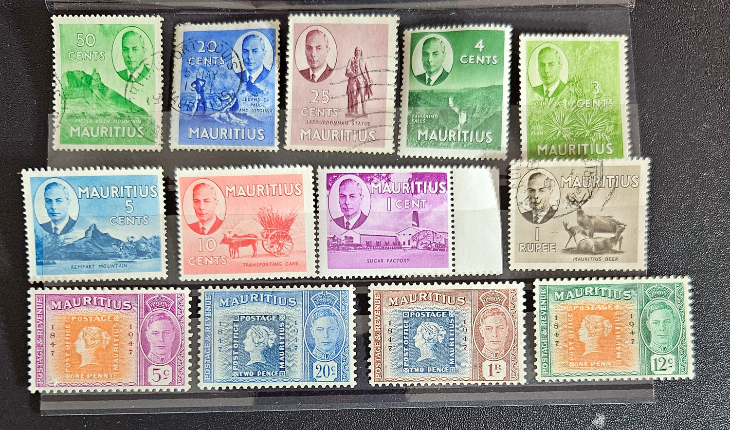 A collection of vintage postage stamps from Mauritius displayed in a row, featuring various designs and denominations.