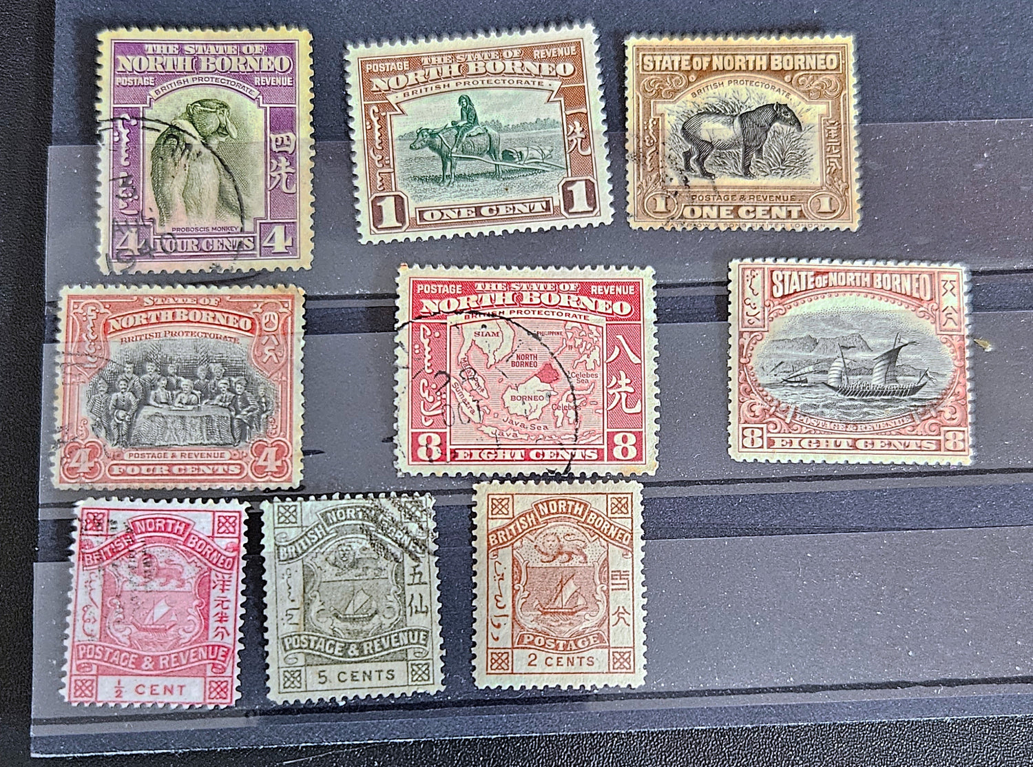A set of vintage postage stamps from North Borneo and Sabah with various designs and denominations.