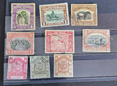 A set of vintage postage stamps from North Borneo and Sabah with various designs and denominations.