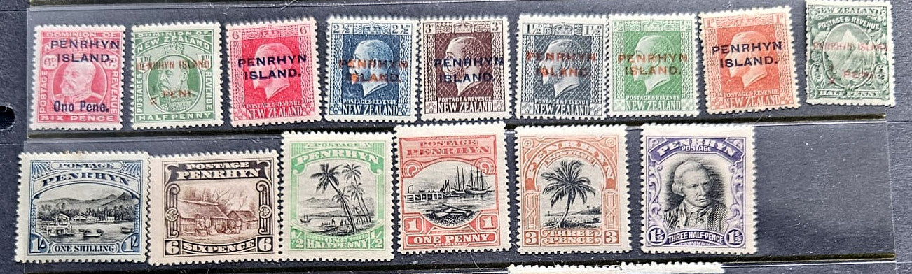 A set of vintage Penrhyn Island postage stamps arranged in two rows on a dark surface. The top row contains six colorful portrait stamps, and the bottom row contains six landscape or architectural stamps in muted red, green, blue, and brown tones.