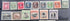 A set of vintage Penrhyn Island postage stamps arranged in two rows on a dark surface. The top row contains six colorful portrait stamps, and the bottom row contains six landscape or architectural stamps in muted red, green, blue, and brown tones.