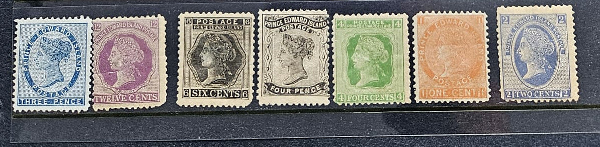 A row of six vintage British Queen Victoria postage stamps of Prince Edward Island in different colors (blue, purple, brown, green, orange, and blue) aligned horizontally on a dark background.