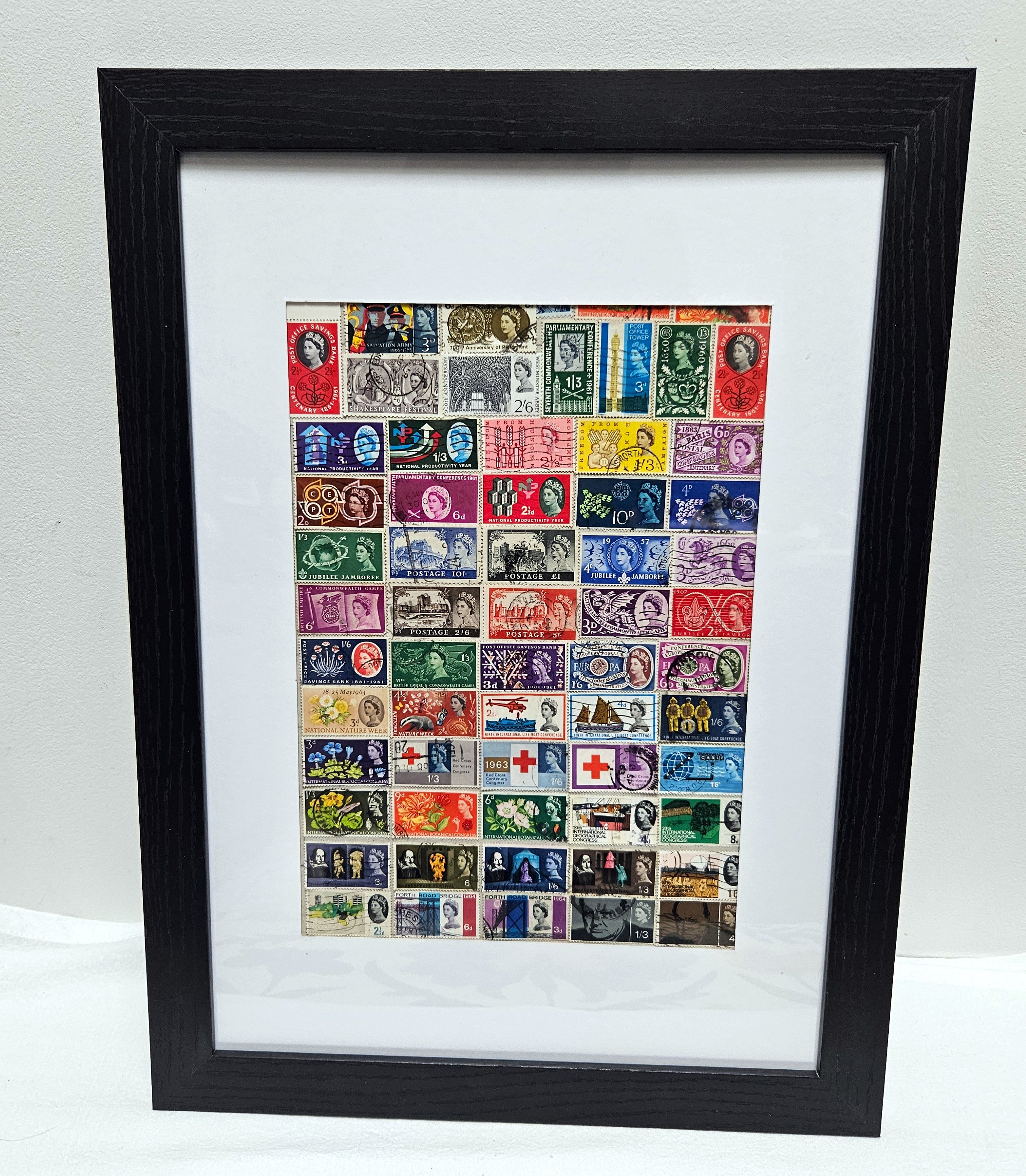 Framed collection of Queen Elizabeth 1953-1966 vintage stamps on a white background