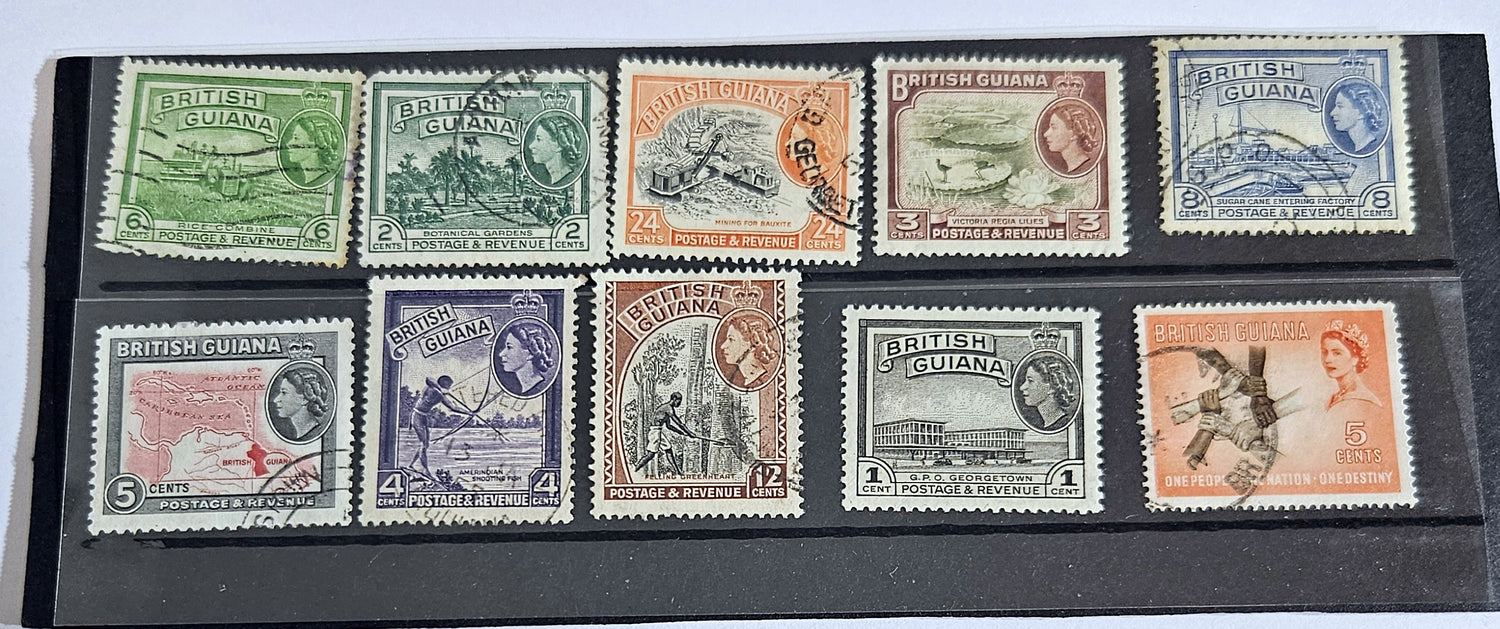 A collection of vintage British Guyana stamps from the reign of King George V, featuring various designs including portraits and imagery of local flora and fauna.