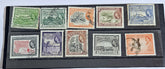 A collection of vintage British Guyana stamps from the reign of King George V, featuring various designs including portraits and imagery of local flora and fauna.