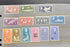 A set of vintage South Georgia postage stamps arranged on a gray binder page. The collection includes stamps in various colors such as green, purple, blue, pink, orange, and brown, featuring wildlife and landscape illustrations.