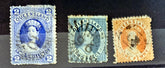 Three vintage postage stamps from Queensland on a dark background