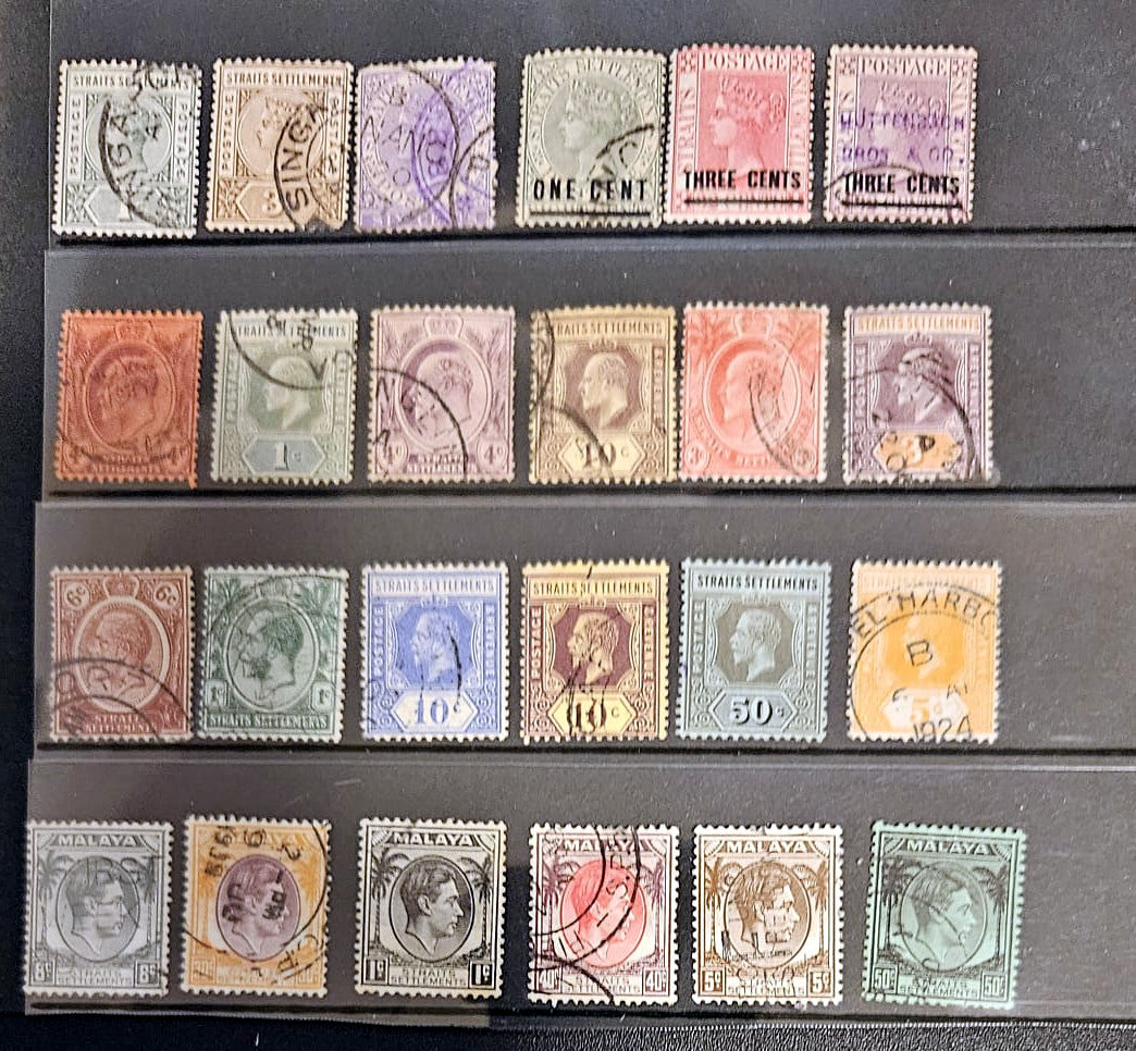 Collection of vintage stamps arranged in a collection holder.