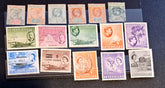 A collection of vintage Seychelles postage stamps arranged on a black surface, showing multiple denominations and colors including green, orange, purple, blue, and red.