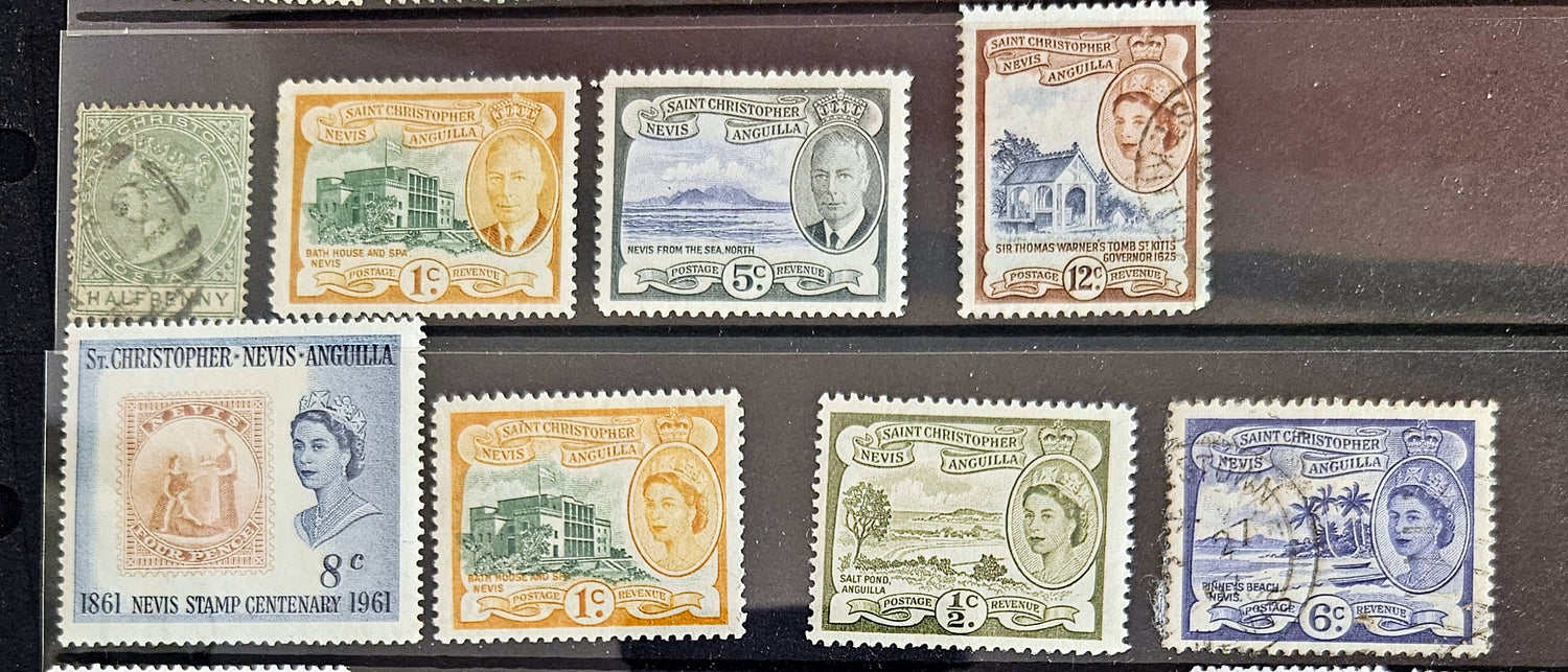 A collection of vintage St Kitts and Nevis stamps displayed against a dark background. The stamps vary in color and design, featuring various denominations and historical figures.