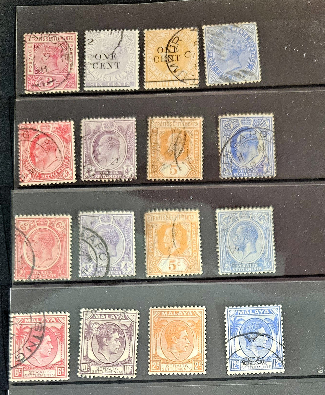 A collection of vintage postage stamps from the Straits Settlements, featuring various colors and designs, displayed on a flat surface.
