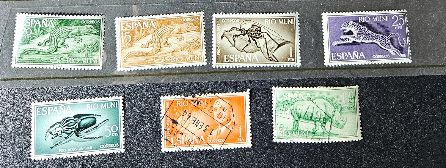 Collection of Spanish stamps on a black background