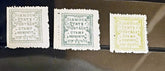 Three vintage Sirmdor State postage stamps displayed side by side on a dark reflective surface. The left stamp is light gray, the middle is greenish-gray, and the right is pale yellow, each with the text &