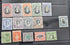 A set of vintage Togoa postage stamps arranged on a black plastic album page, showing multiple colors and denominations.