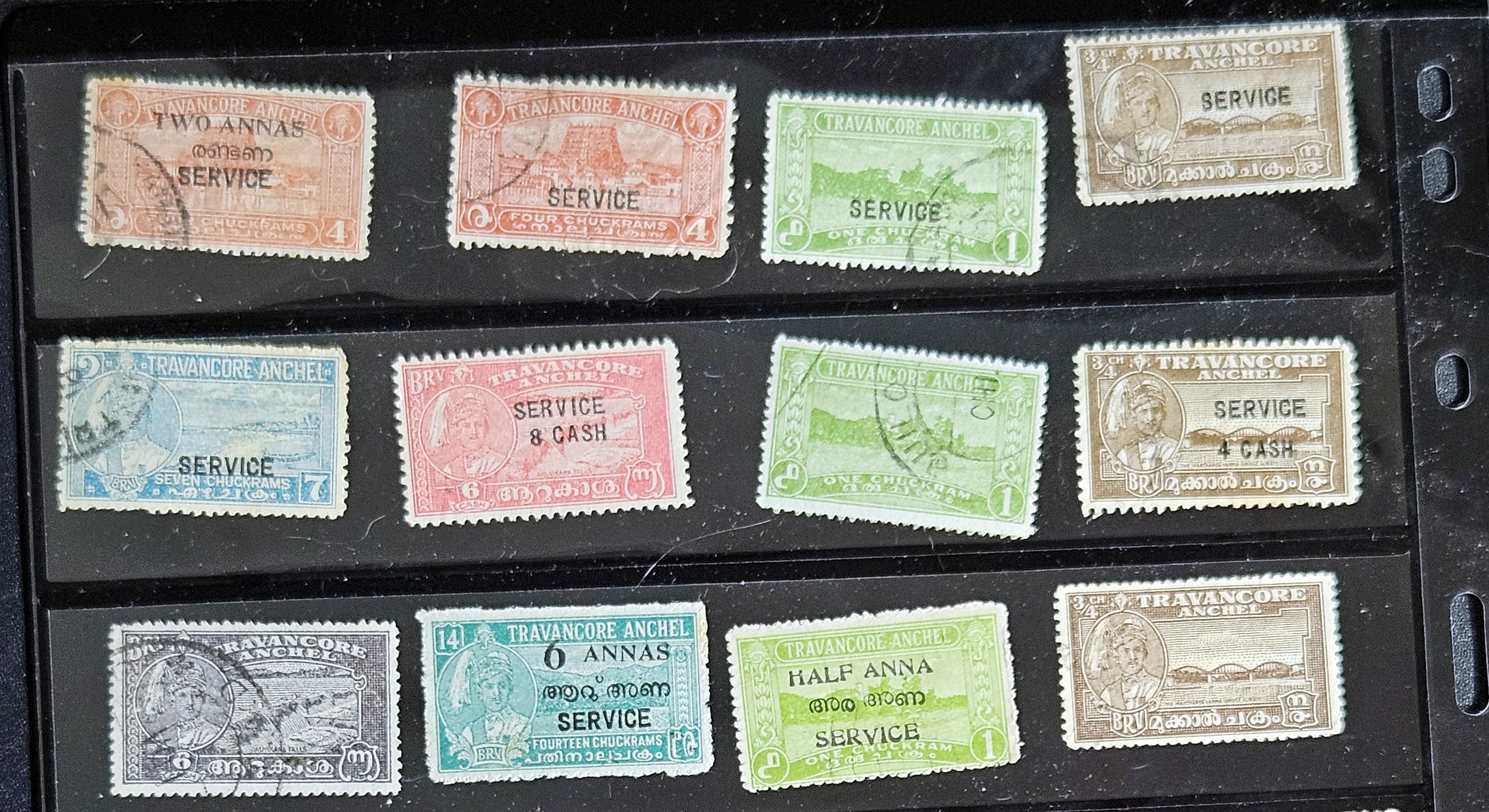 A collection of various Indian postage stamps displayed in a row, showcasing different colors and designs.