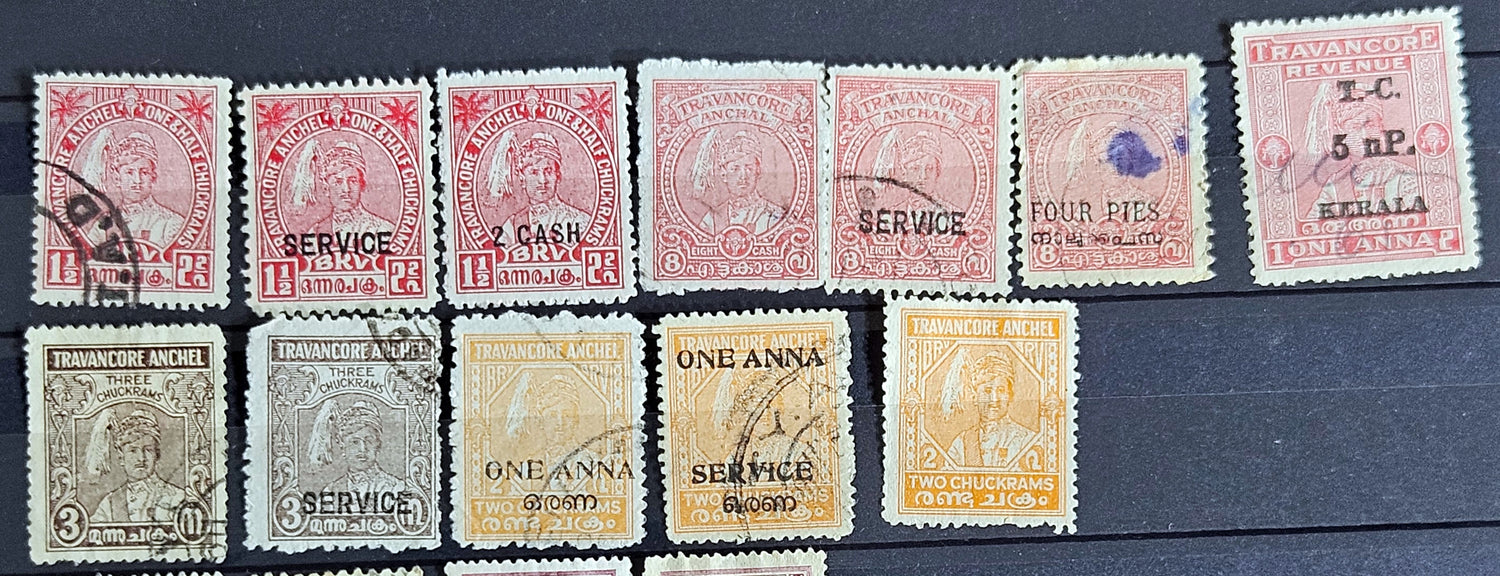 A collection of various Indian postage stamps displayed in a row, showcasing different colors and designs.