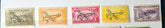 Set of four vintage postage stamps with airplane designs on a textured background.