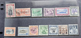 A set of vintage Western Samoa postage stamps displayed on a black binder page, showing multiple colors and designs from the late 19th to early 20th century.