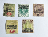 A collection of vintage British Commonwealth Bechuanaland Protectorate stamps featuring various denominations and kings from the reign of George V to Elizabeth II.